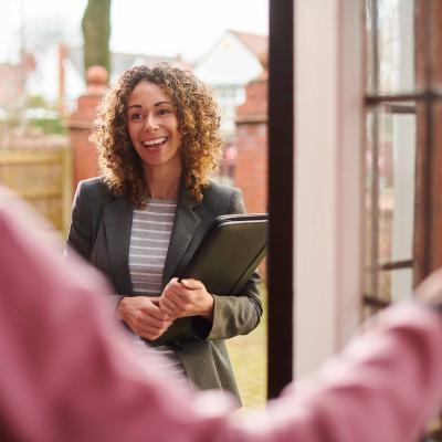 Social worker smiling by door